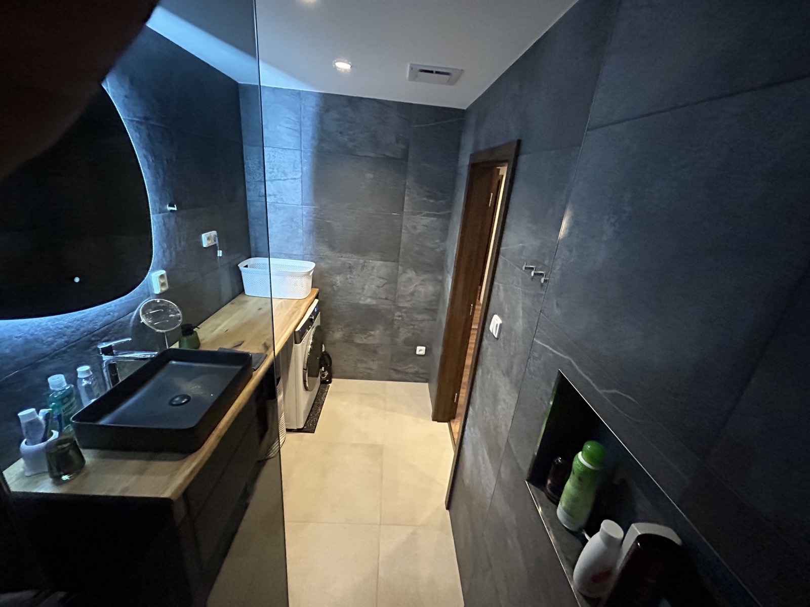 Tmavá koupelna s walk-in sprchou a LED zrcadlem